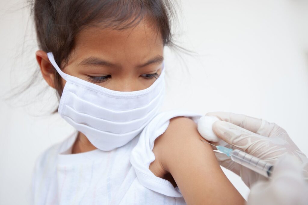 Preteen Girl Wearing A Mask Getting Vaccinated